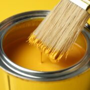 paint can and brush on yellow background close up 2023 11 27 04 51 03 utc 1