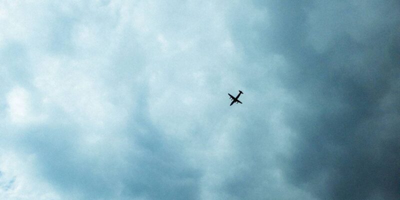 low angle shot of a plane in the blue cloudy sky 2023 11 27 05 00 44 utc 1