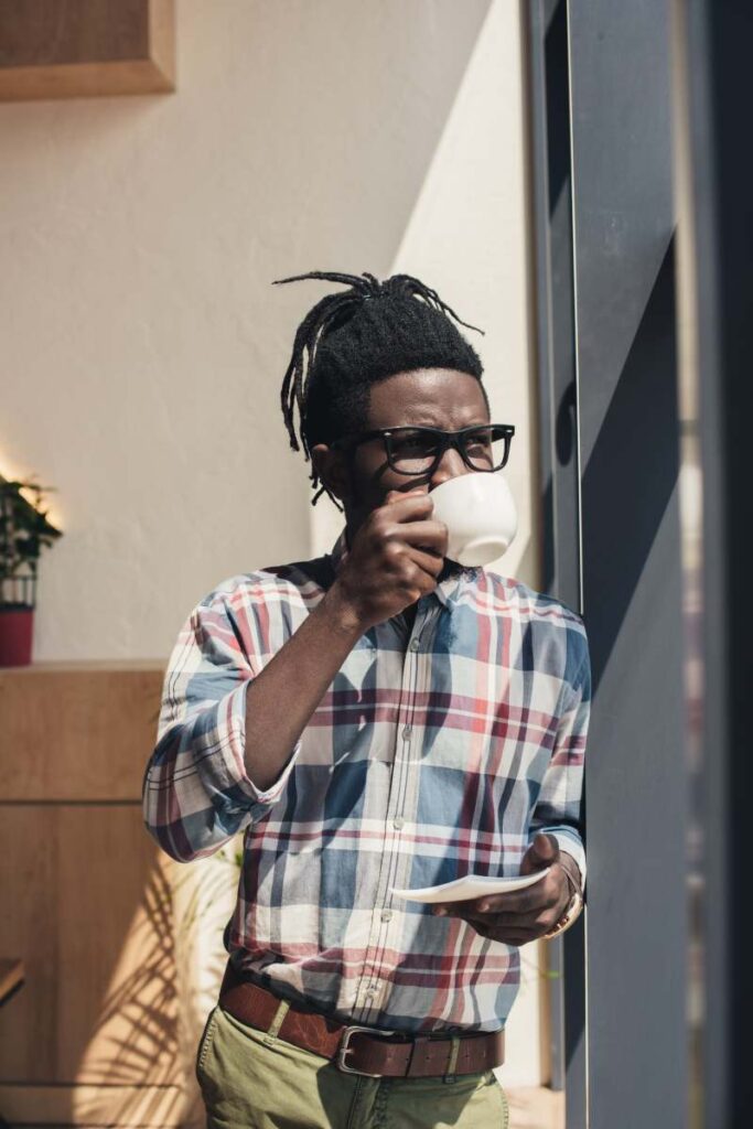 african american man in eyeglasses drinking coffee 2023 11 27 04 59 37 utc 1