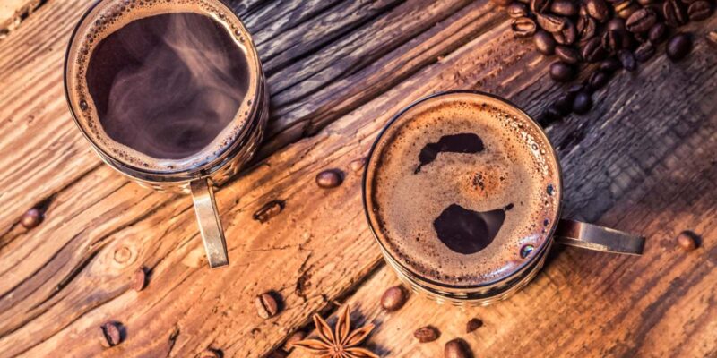 closeup of hot coffee in old wooden table 2023 11 27 05 12 20 utc 1